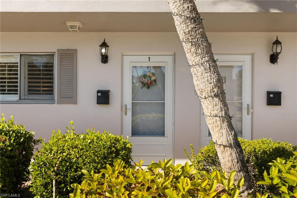 1686 Blue Point Avenue, Unit A1 Naples, FL 34102 - Photo 23 of 38 a front view of a house