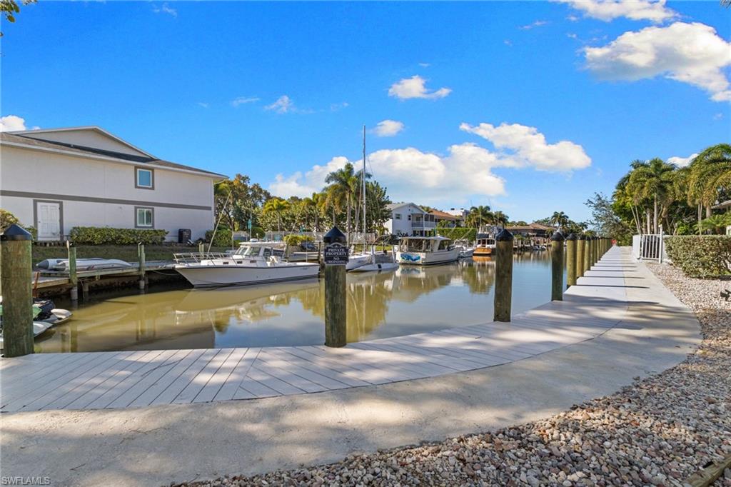 1686 Blue Point Avenue, Unit A1 Naples, FL 34102 - Photo 26 of 38 a view of a swimming pool with outdoor seating
