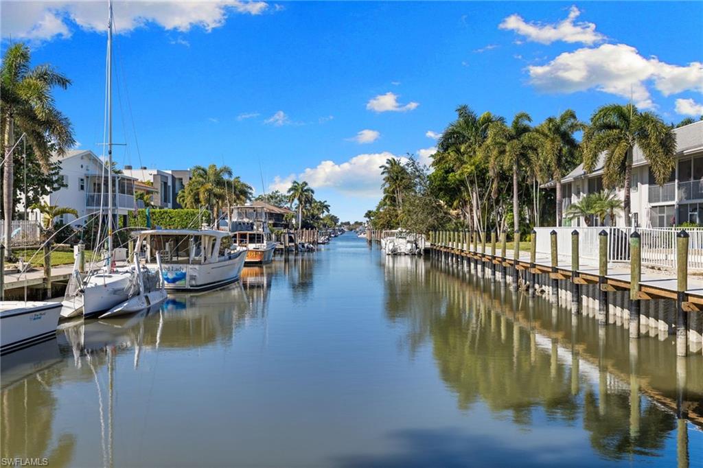 1686 Blue Point Avenue, Unit A1 Naples, FL 34102 - Photo 27 of 38 a view of a lake with a house