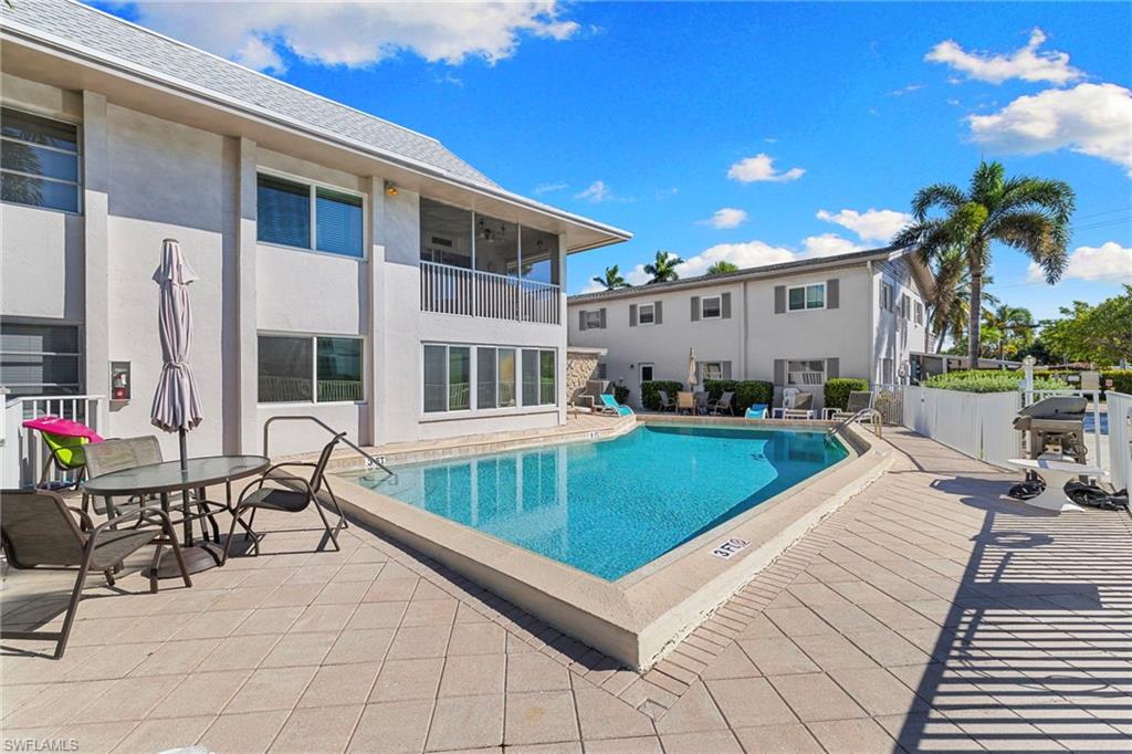 1686 Blue Point Avenue, Unit A1 Naples, FL 34102 - Photo 32 of 38 a view of a house with backyard and sitting area