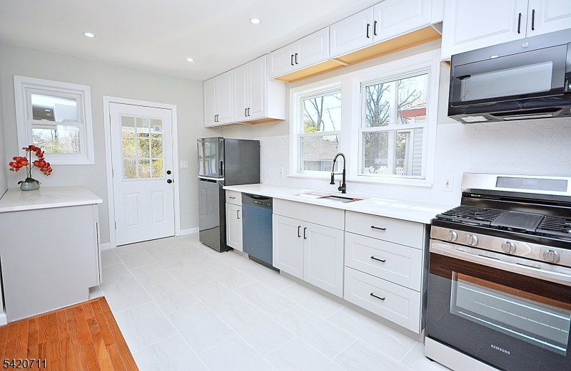 1324 George Street Plainfield, NJ 07062 - Photo 12 of 26 a kitchen with a sink cabinets and appliances