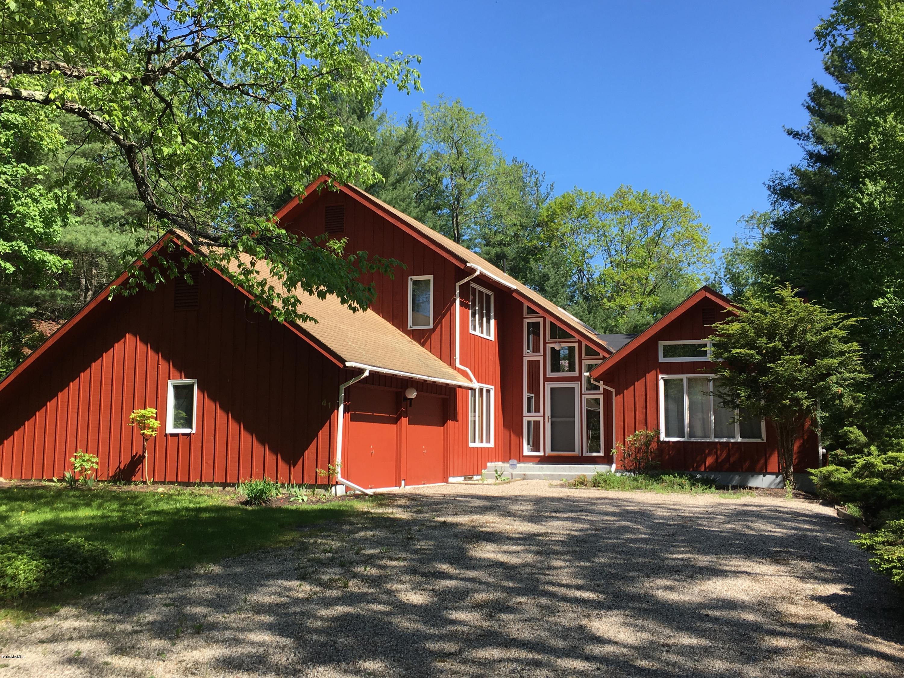 41 Pine Knoll Road Lenox, MA 01240 - Photo 1 of 37 a backyard of a house with wooden fence and trees