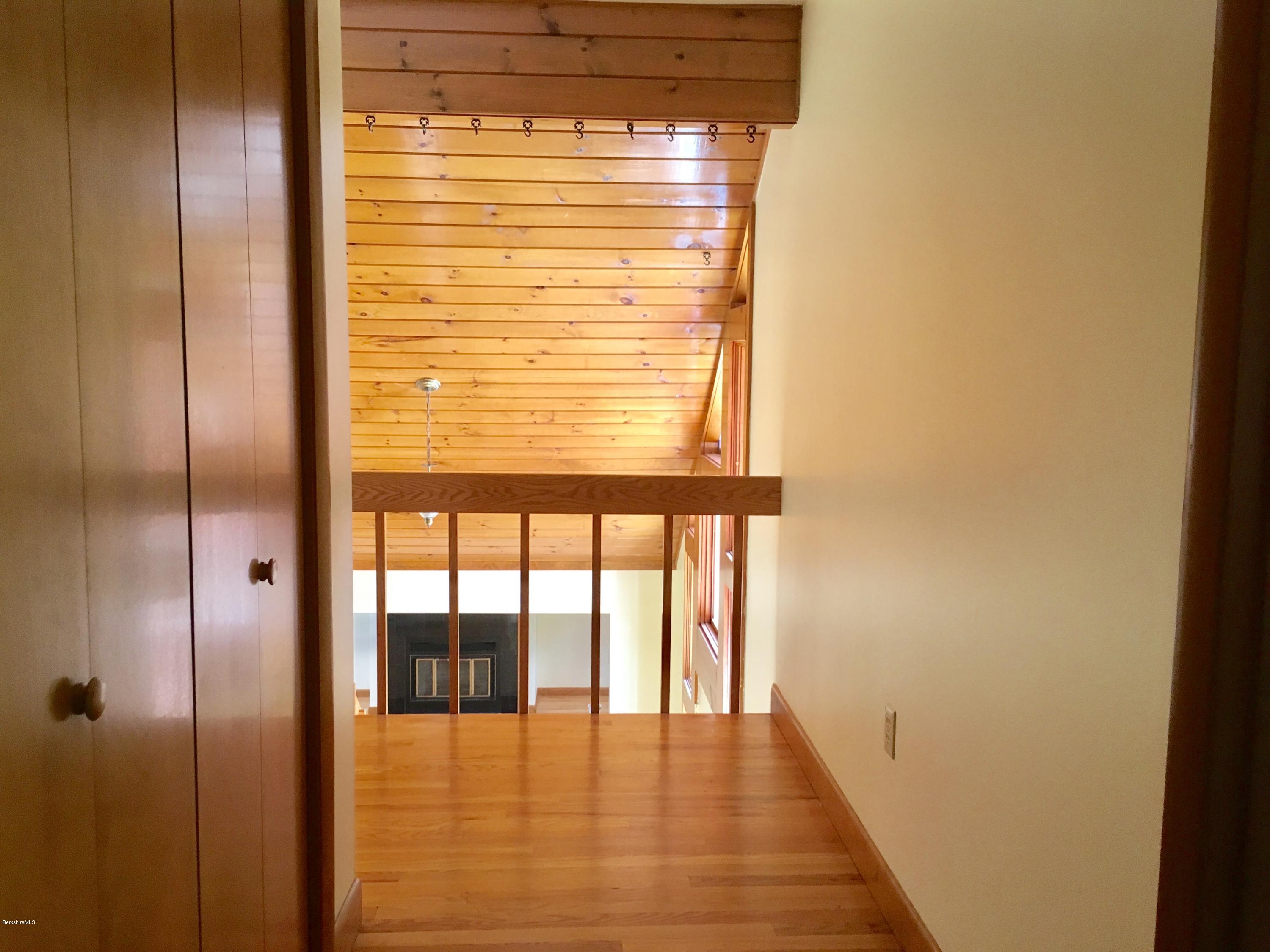 41 Pine Knoll Road Lenox, MA 01240 - Photo 12 of 37 a view of an empty room with wooden floor and a window