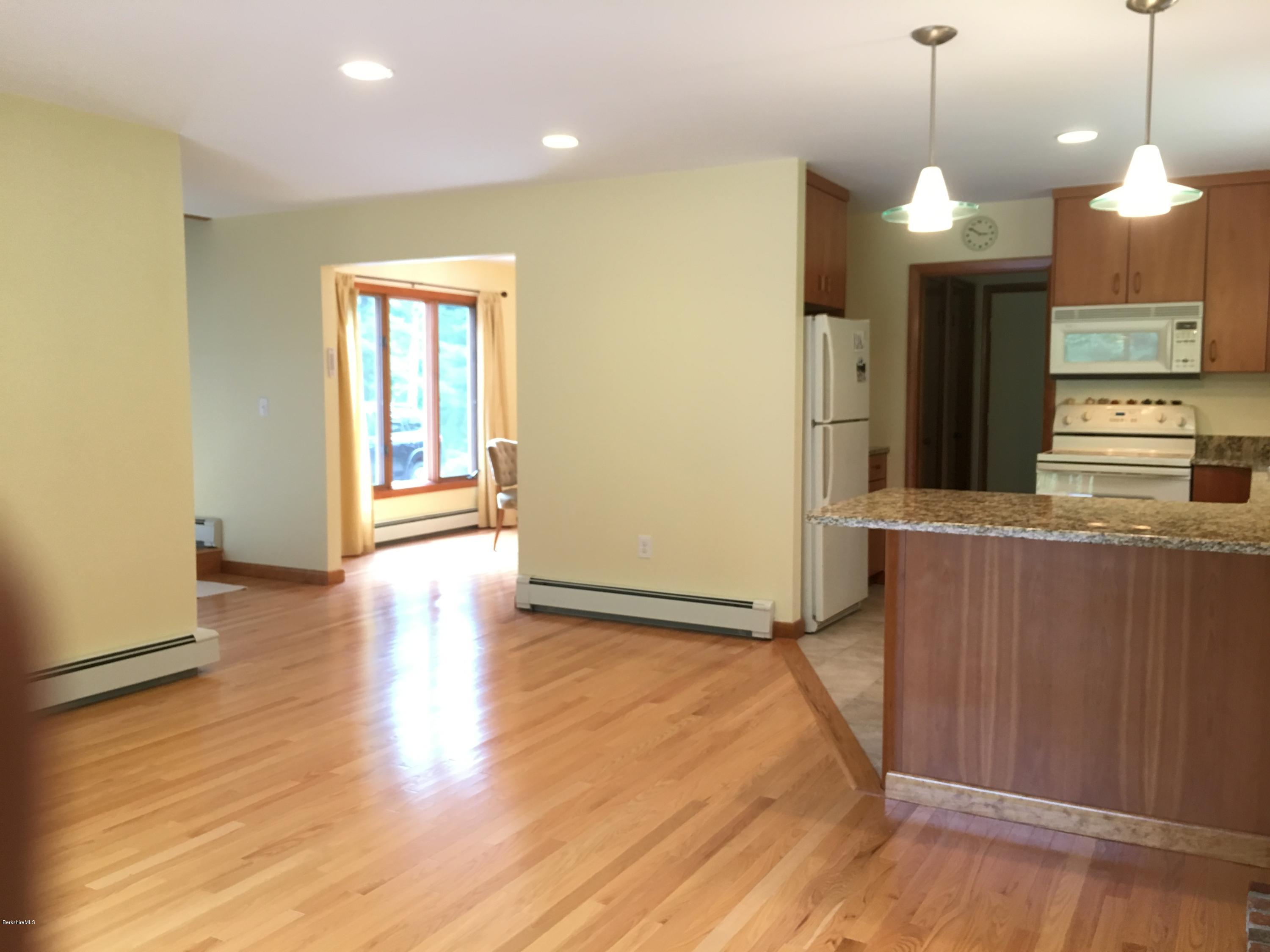 41 Pine Knoll Road Lenox, MA 01240 - Photo 14 of 37 a view of a kitchen with a stove wooden floor and a kitchen space
