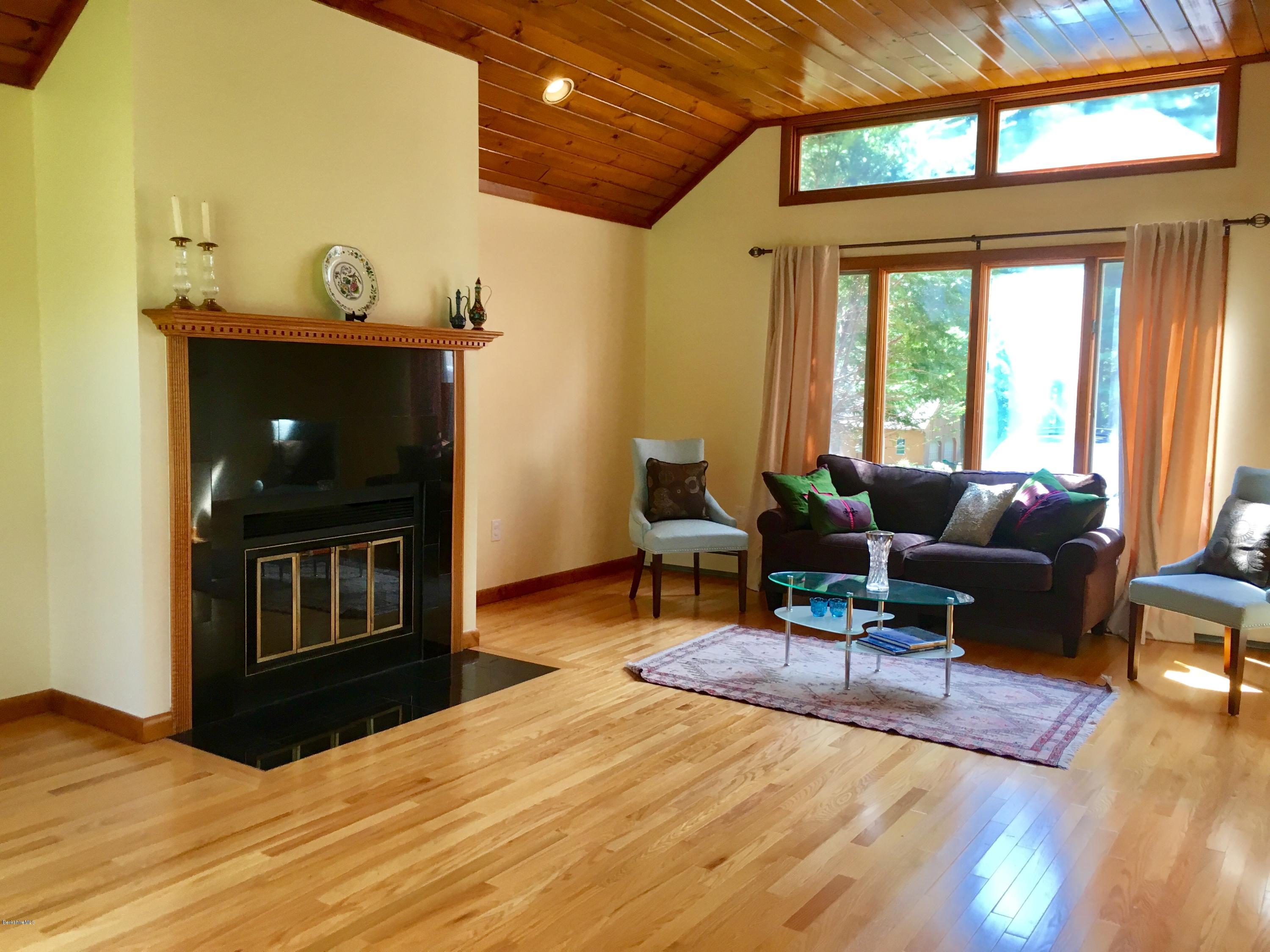 41 Pine Knoll Road Lenox, MA 01240 - Photo 18 of 37 a living room with furniture a fireplace and a table