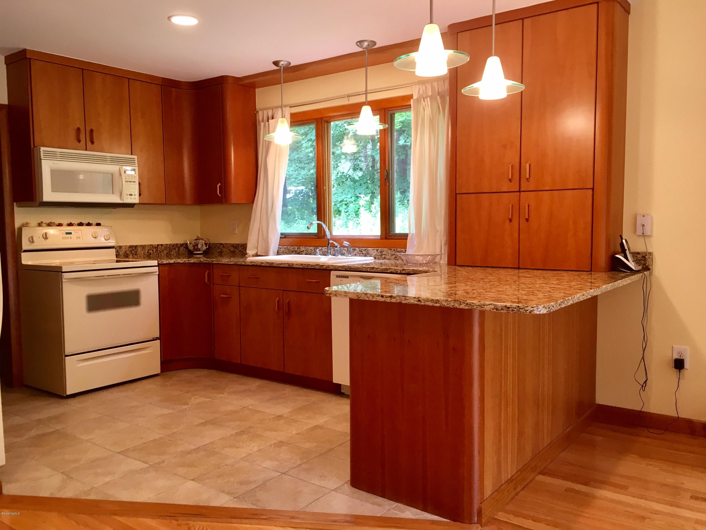 41 Pine Knoll Road Lenox, MA 01240 - Photo 3 of 37 a kitchen with stainless steel appliances granite countertop a sink a stove and a refrigerator