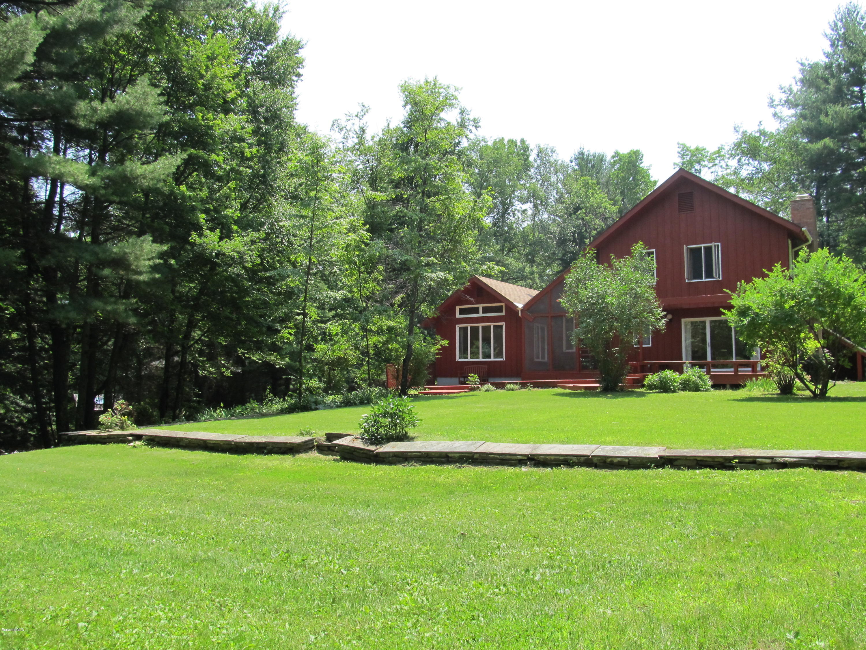 41 Pine Knoll Road Lenox, MA 01240 - Photo 24 of 37 a front view of a house with a yard and trees