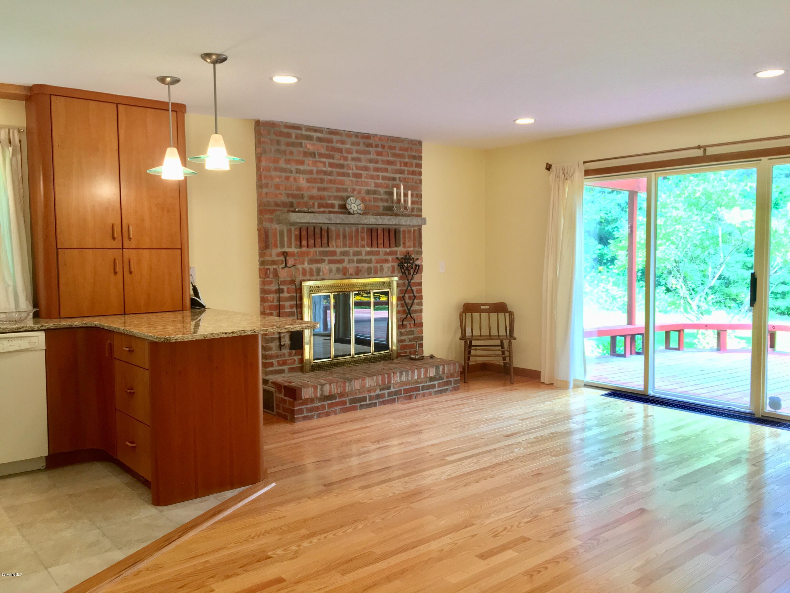 41 Pine Knoll Road Lenox, MA 01240 - Photo 5 of 37 a view of an empty room with window wooden floor and a kitchen