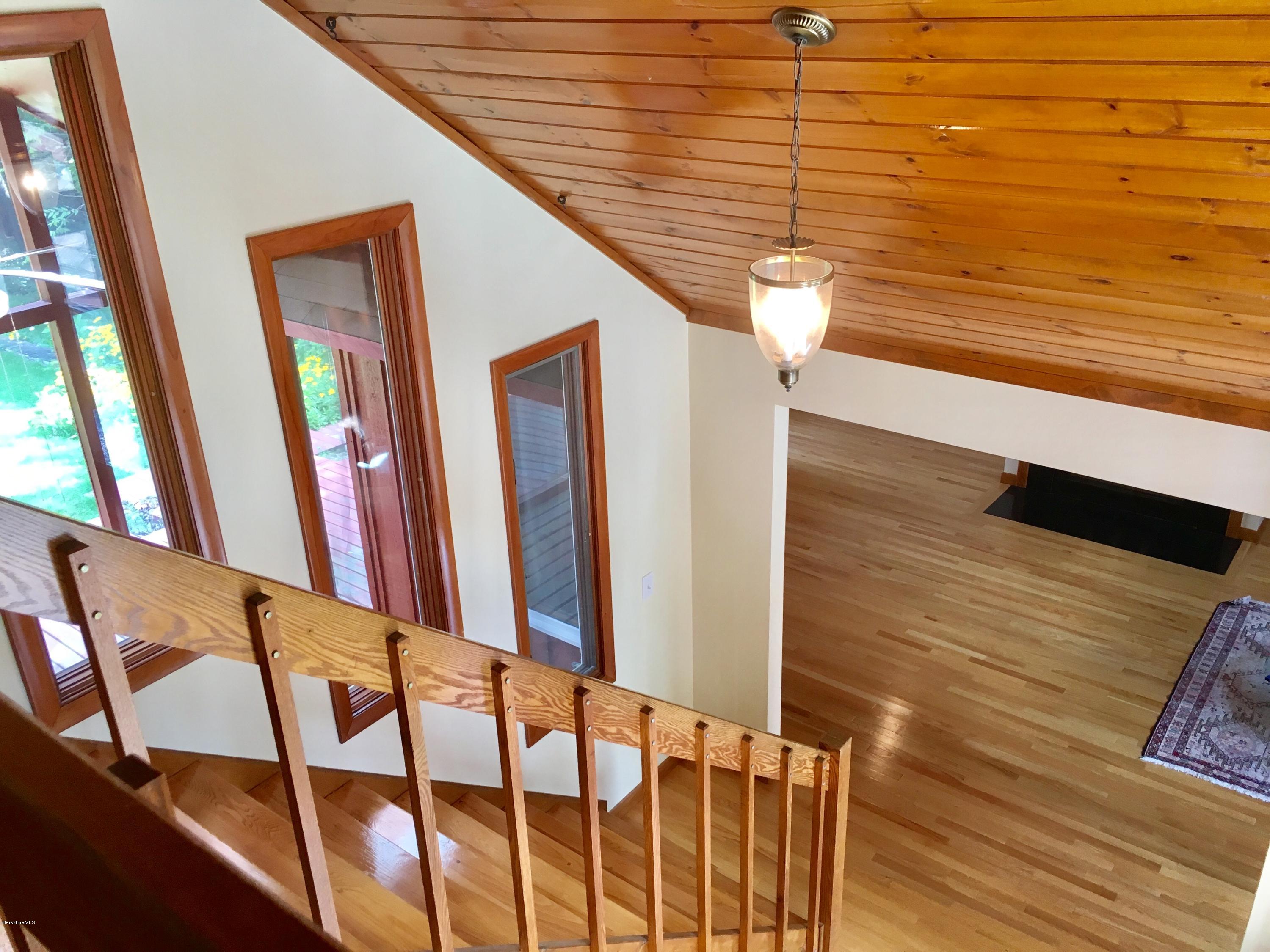 41 Pine Knoll Road Lenox, MA 01240 - Photo 6 of 37 a view of a hallway with wooden floor and staircase