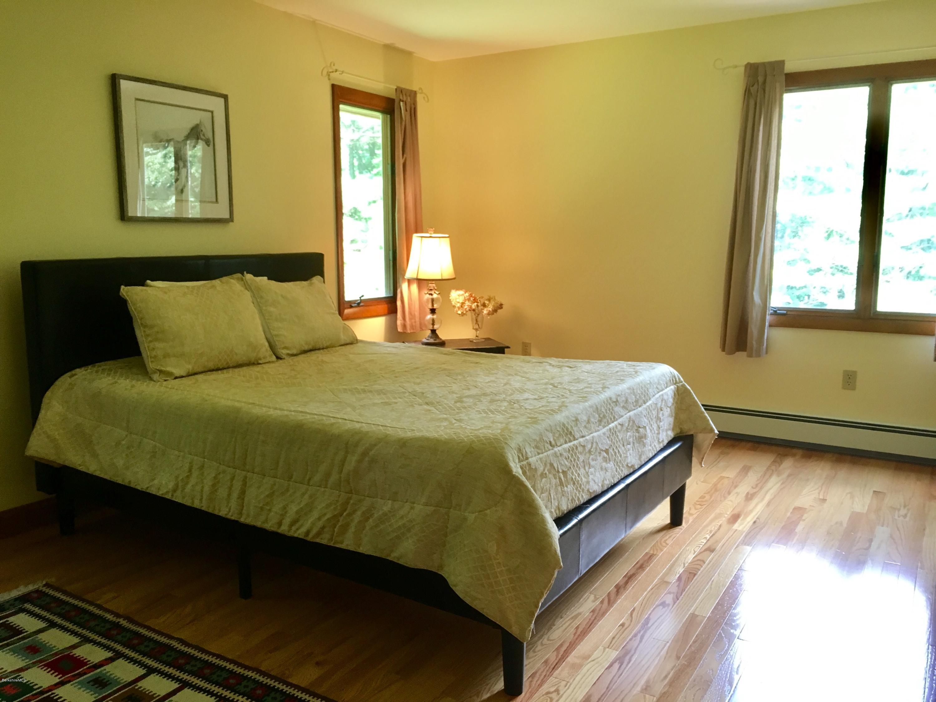 41 Pine Knoll Road Lenox, MA 01240 - Photo 7 of 37 a large bed sitting in a bedroom next to a window