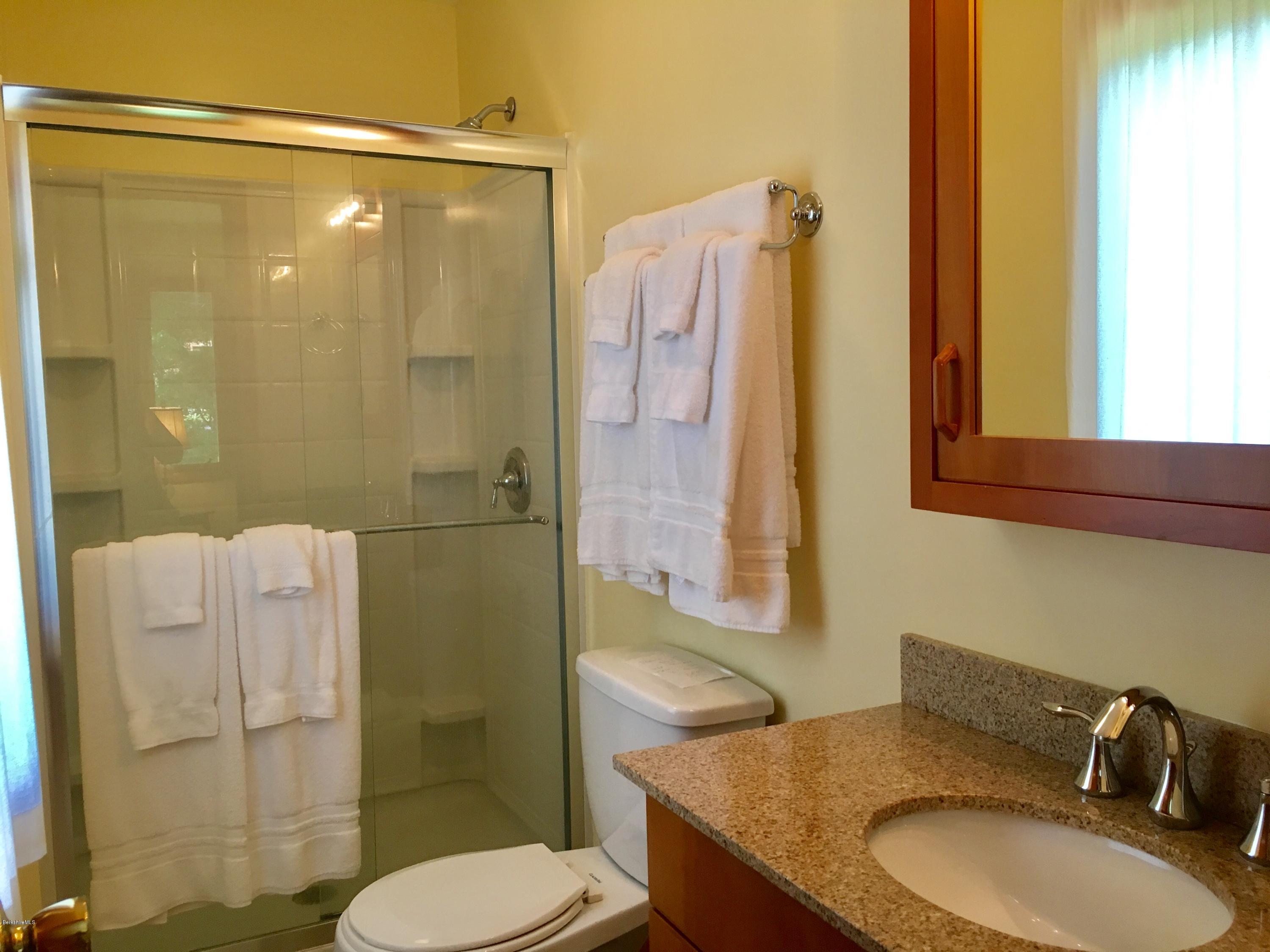 41 Pine Knoll Road Lenox, MA 01240 - Photo 8 of 37 a bathroom with a granite countertop sink toilet and shower