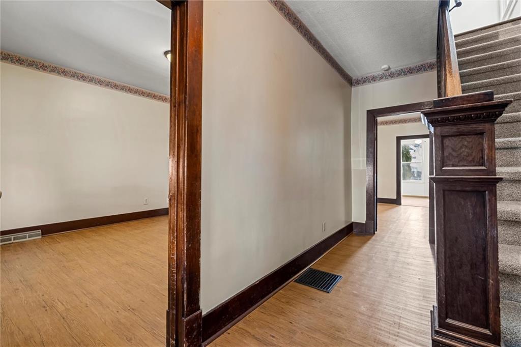 325 Walnut Street Vandergrift, PA 15690 - Photo 11 of 29 a view of a hallway with wooden floor and staircase