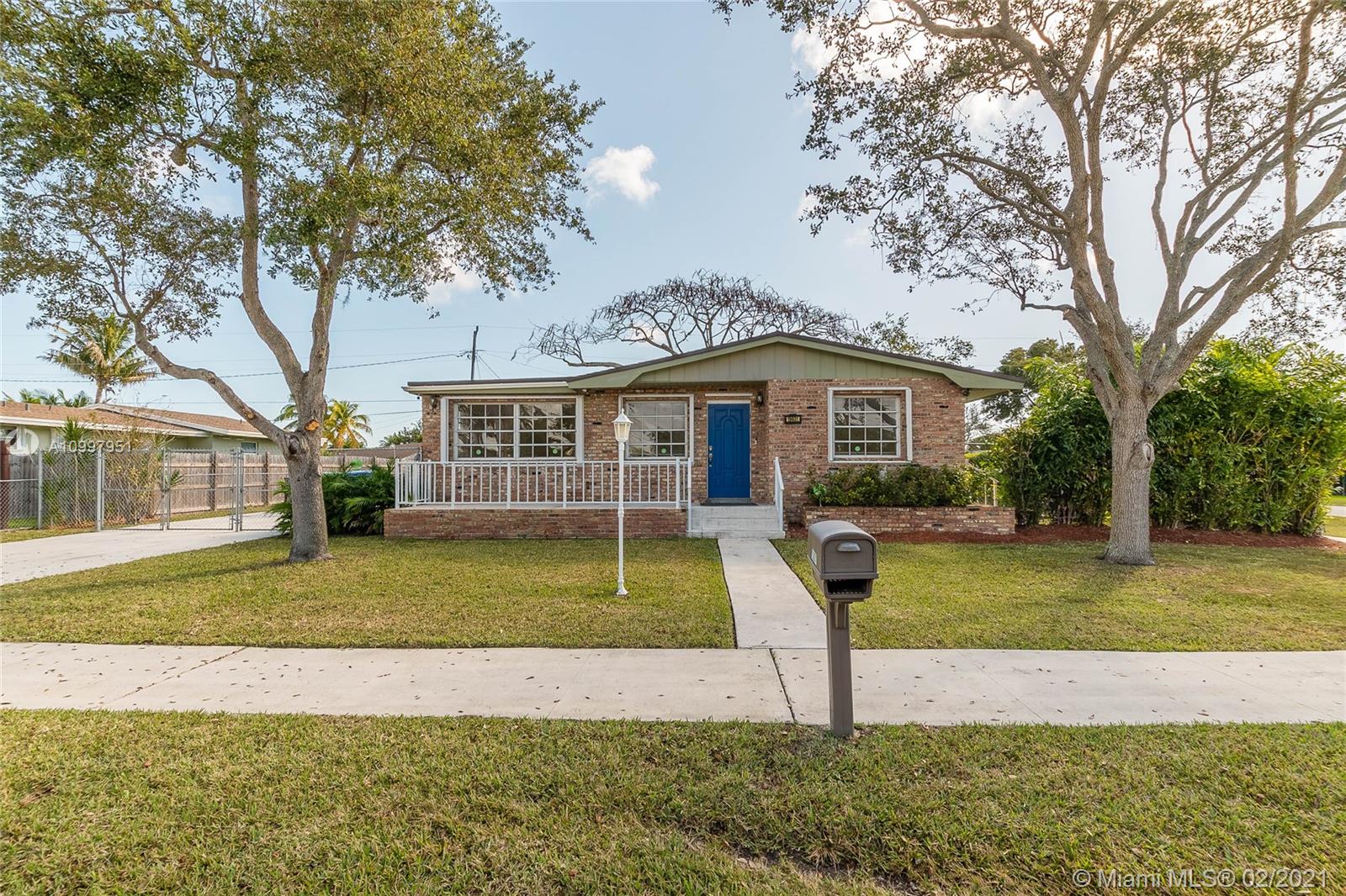 19931 Dothan Road Cutler Bay, FL 33157 - Photo 1 of 27 a front view of a house with garden and trees