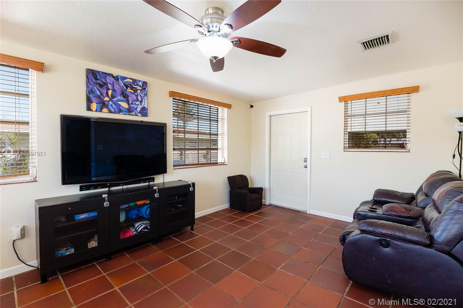 19931 Dothan Road Cutler Bay, FL 33157 - Photo 12 of 27 a living room with furniture and a flat screen tv