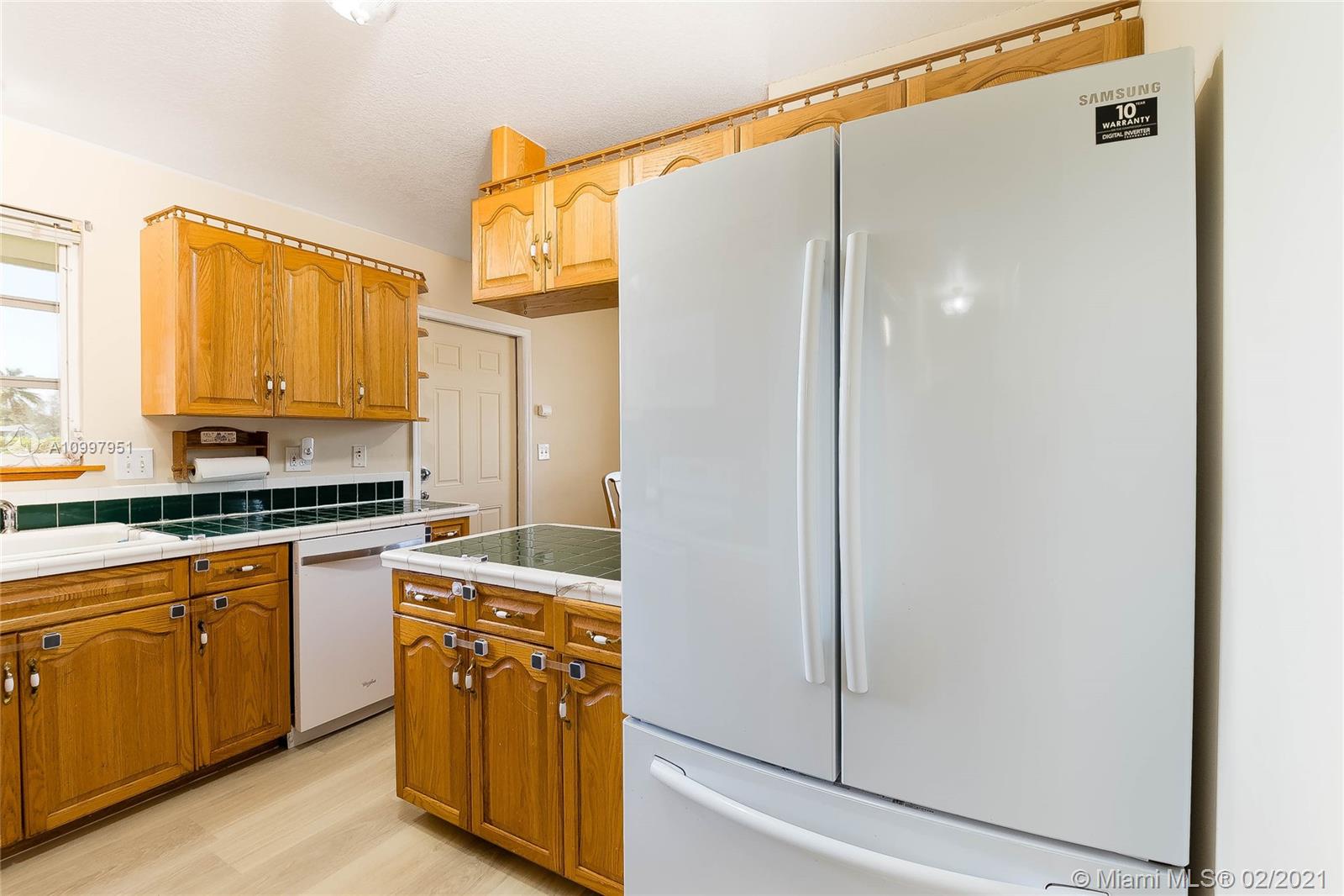 19931 Dothan Road Cutler Bay, FL 33157 - Photo 14 of 27 a kitchen with stainless steel appliances granite countertop a refrigerator and a sink