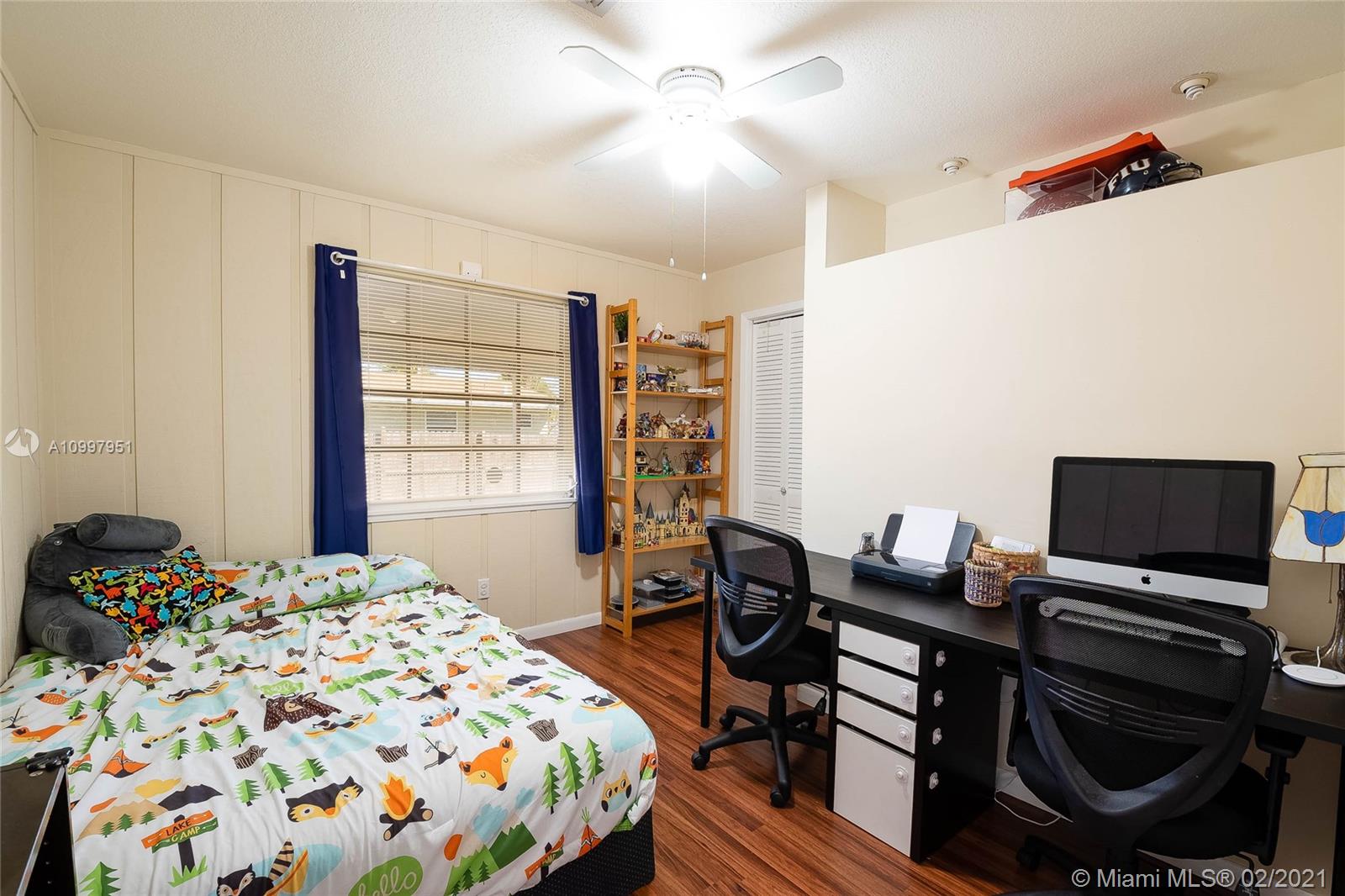 19931 Dothan Road Cutler Bay, FL 33157 - Photo 17 of 27 a bedroom that has a bed and a chair in it