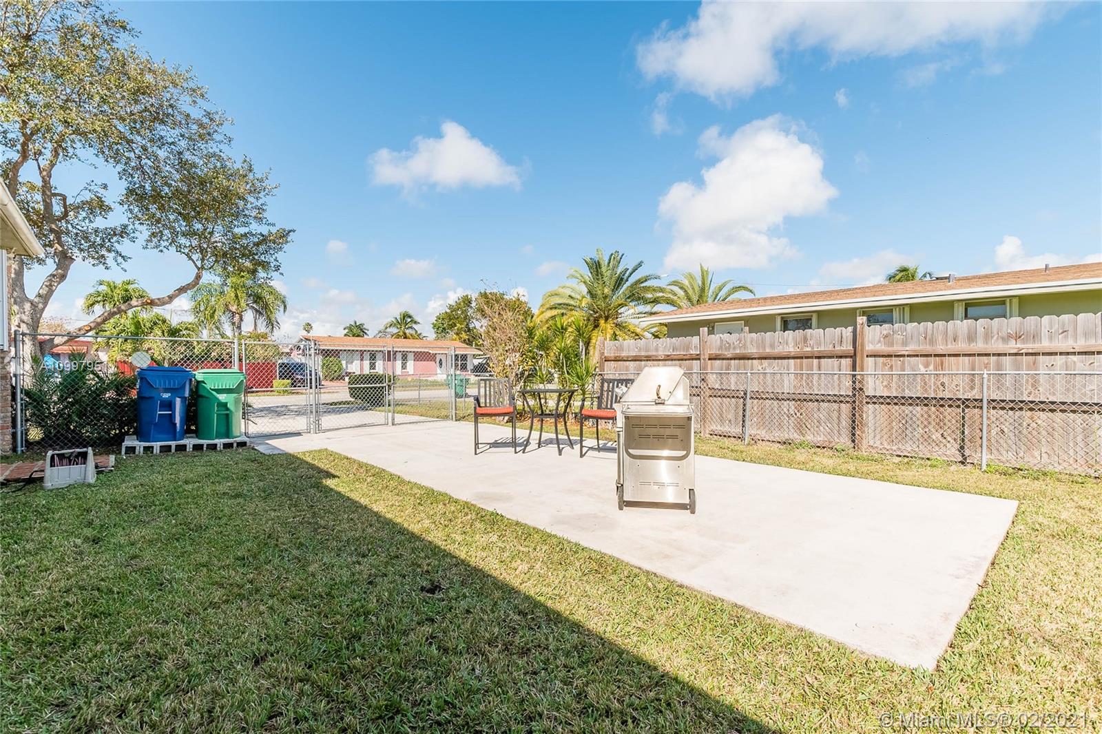 19931 Dothan Road Cutler Bay, FL 33157 - Photo 20 of 27 a view of a swimming pool with an outdoor seating and a yard