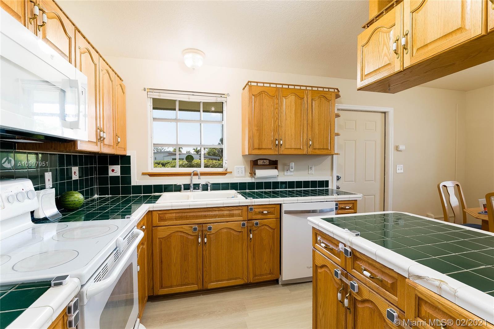 19931 Dothan Road Cutler Bay, FL 33157 - Photo 3 of 27 a kitchen with stainless steel appliances granite countertop a stove a sink and a microwave