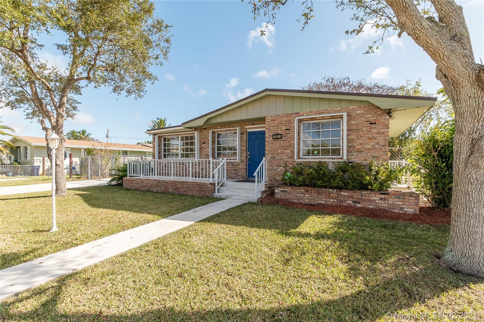 19931 Dothan Road Cutler Bay, FL 33157 - Photo 25 of 27 a front view of a house with garden