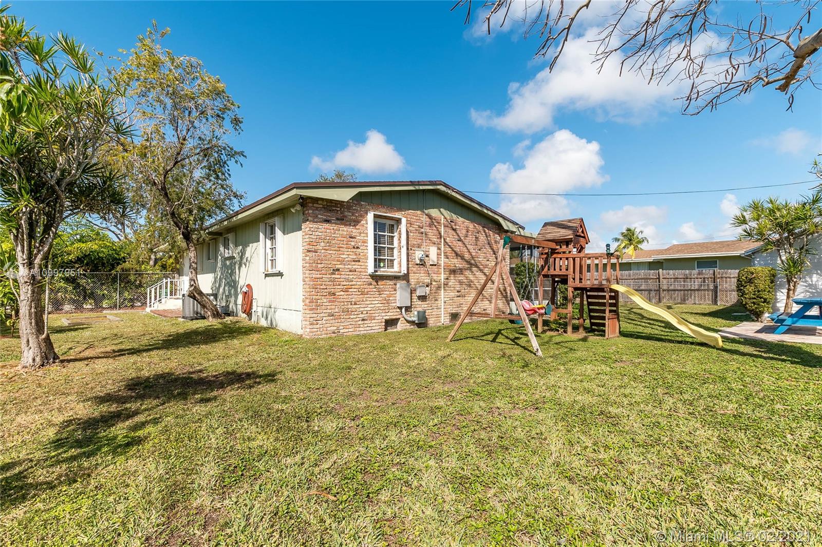 19931 Dothan Road Cutler Bay, FL 33157 - Photo 26 of 27 a front view of a house with a yard