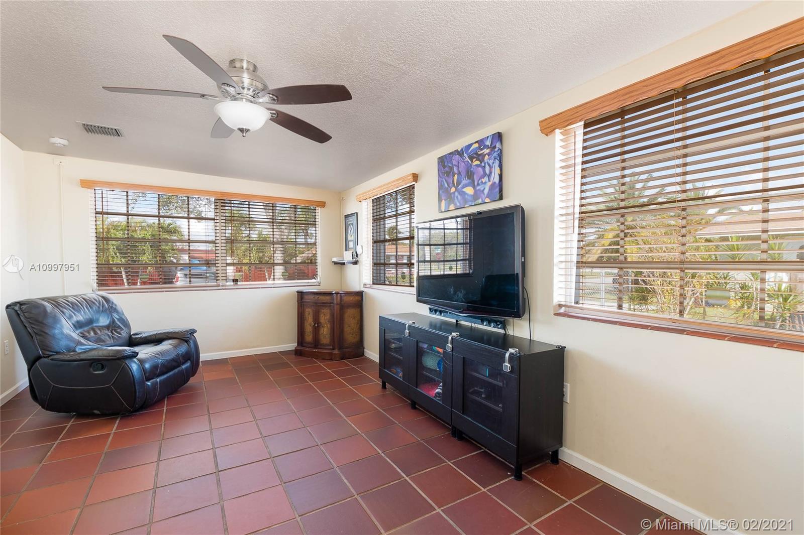 19931 Dothan Road Cutler Bay, FL 33157 - Photo 5 of 27 a living room with furniture and a flat screen tv