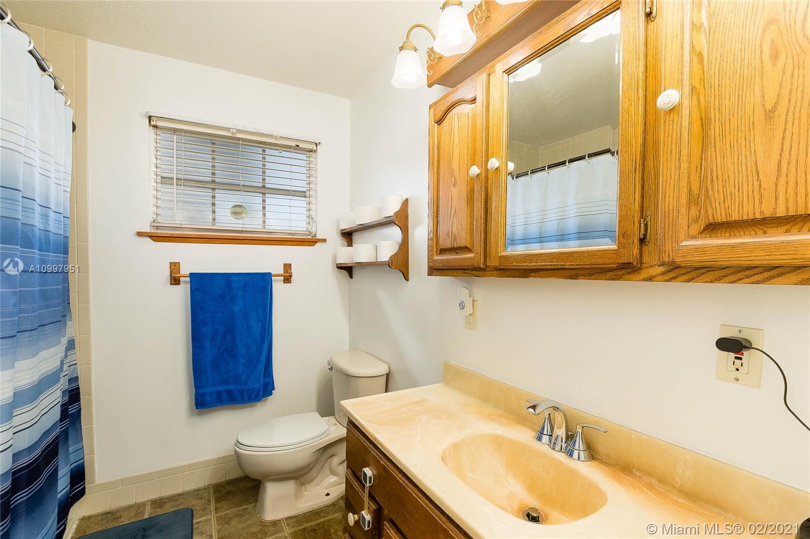 19931 Dothan Road Cutler Bay, FL 33157 - Photo 7 of 27 a bathroom with a sink toilet and mirror