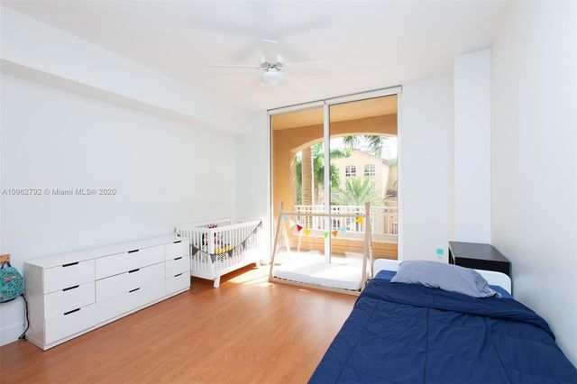 a spacious bedroom with a bed and a window