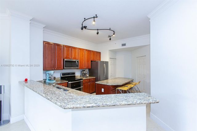 a kitchen with stainless steel appliances granite countertop a sink and a granite counter tops