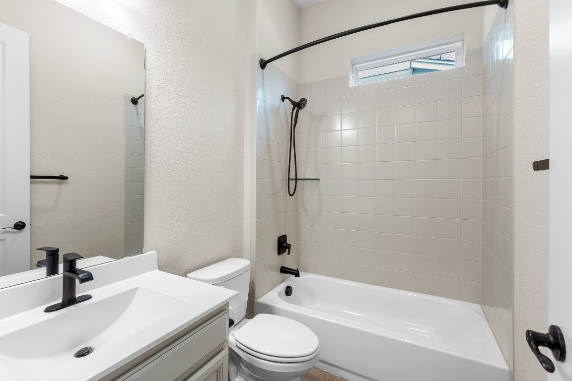1046 Hazy Hills Loop Dripping Springs, TX 78620 - Photo 18 of 35 a bathroom with a sink a toilet and a shower