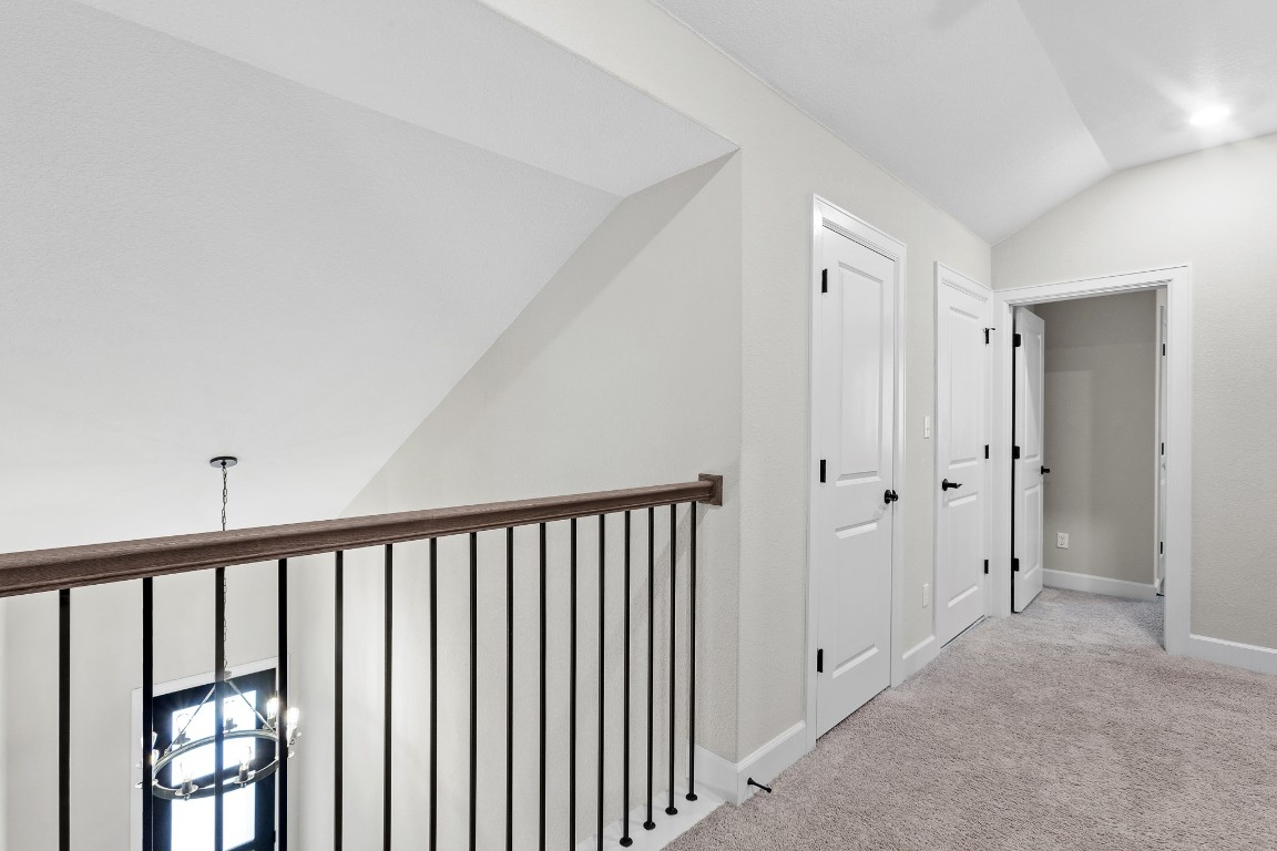 1046 Hazy Hills Loop Dripping Springs, TX 78620 - Photo 22 of 35 a view of a hallway with wooden floor and staircase
