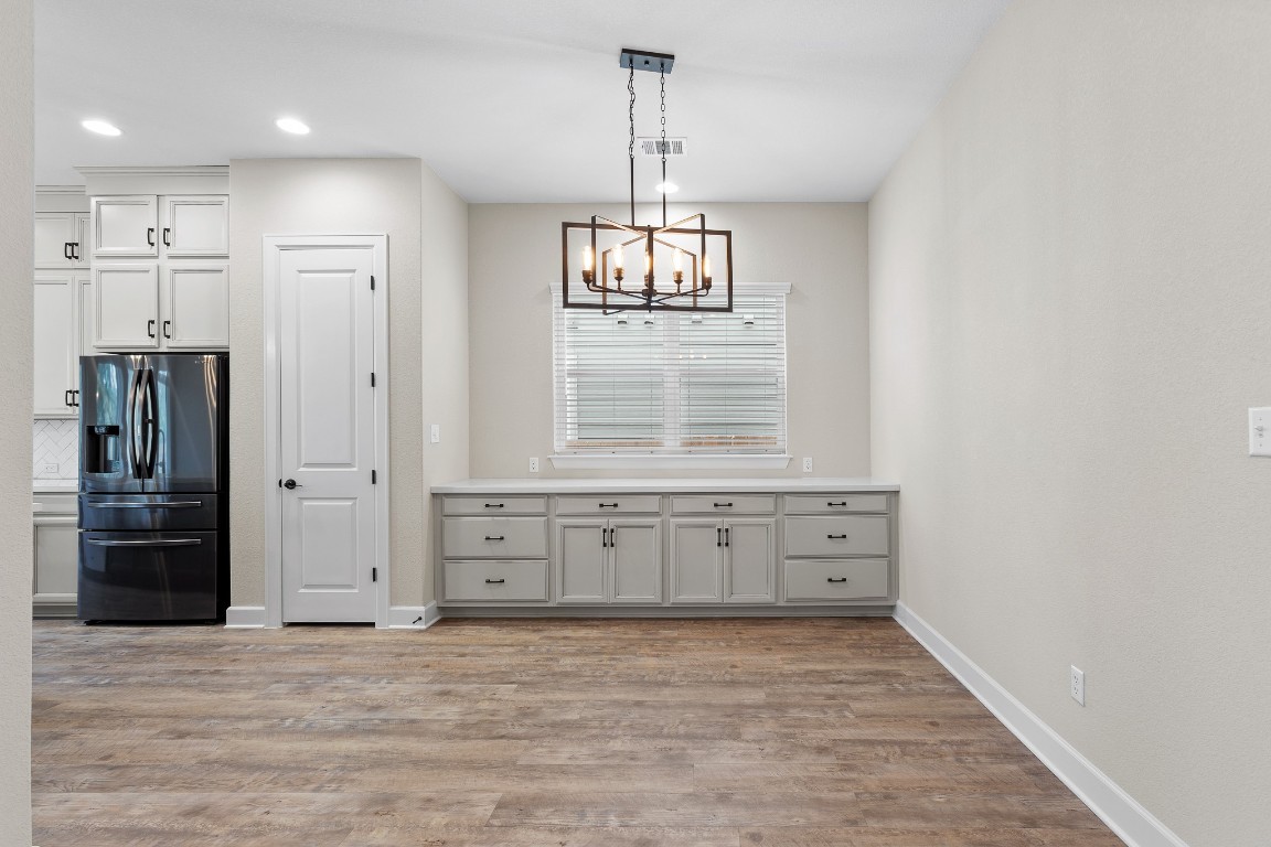 1046 Hazy Hills Loop Dripping Springs, TX 78620 - Photo 4 of 35 a view of a kitchen from the hallway