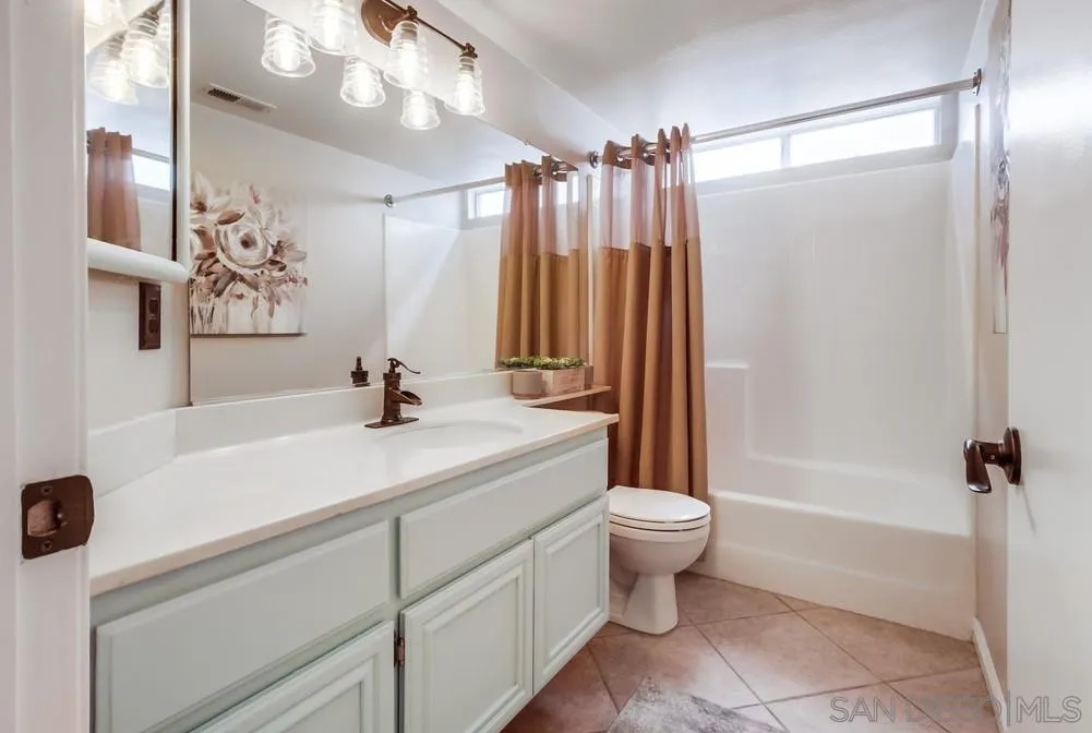 1507 Promontory Ridge Way Vista, CA 92081 - Photo 13 of 28 a bathroom with a sink a toilet a mirror and shower
