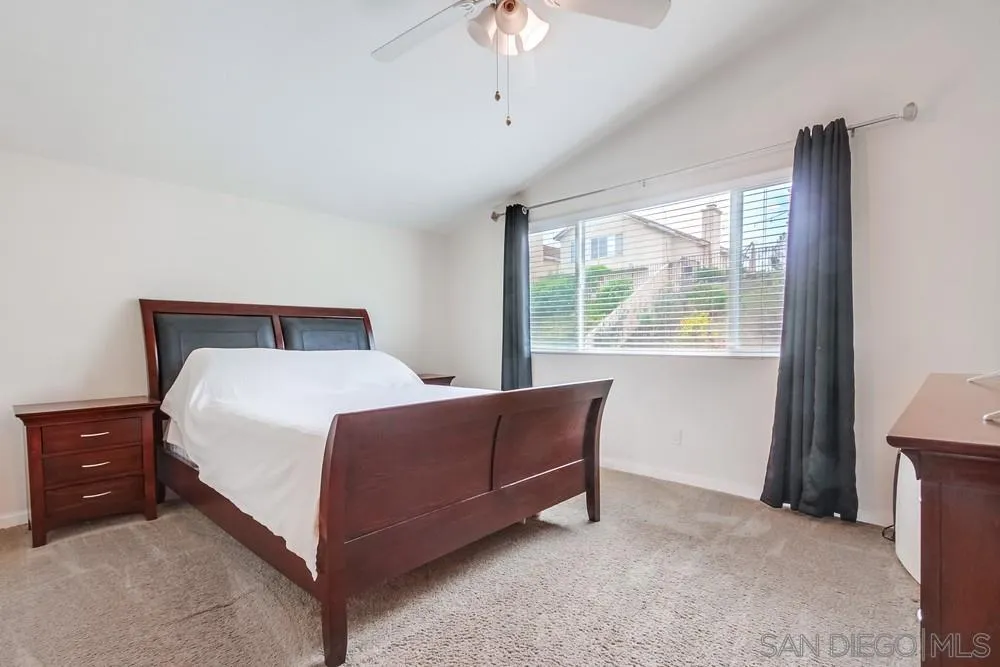 1507 Promontory Ridge Way Vista, CA 92081 - Photo 14 of 28 a bed room with a bed and a chandelier