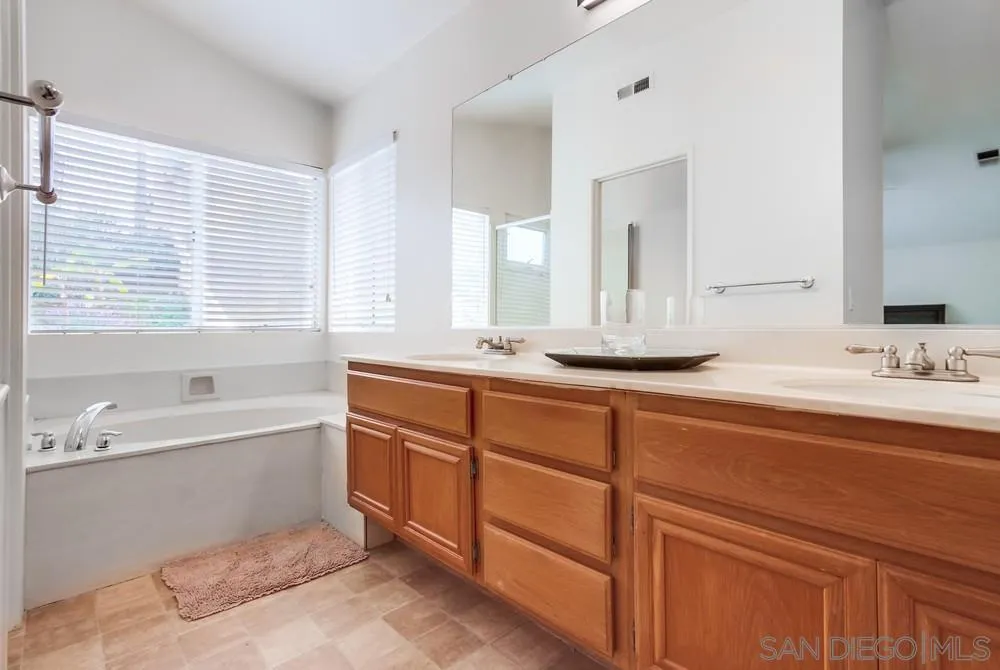 1507 Promontory Ridge Way Vista, CA 92081 - Photo 15 of 28 a bathroom with double vanity sinks and a bathtub