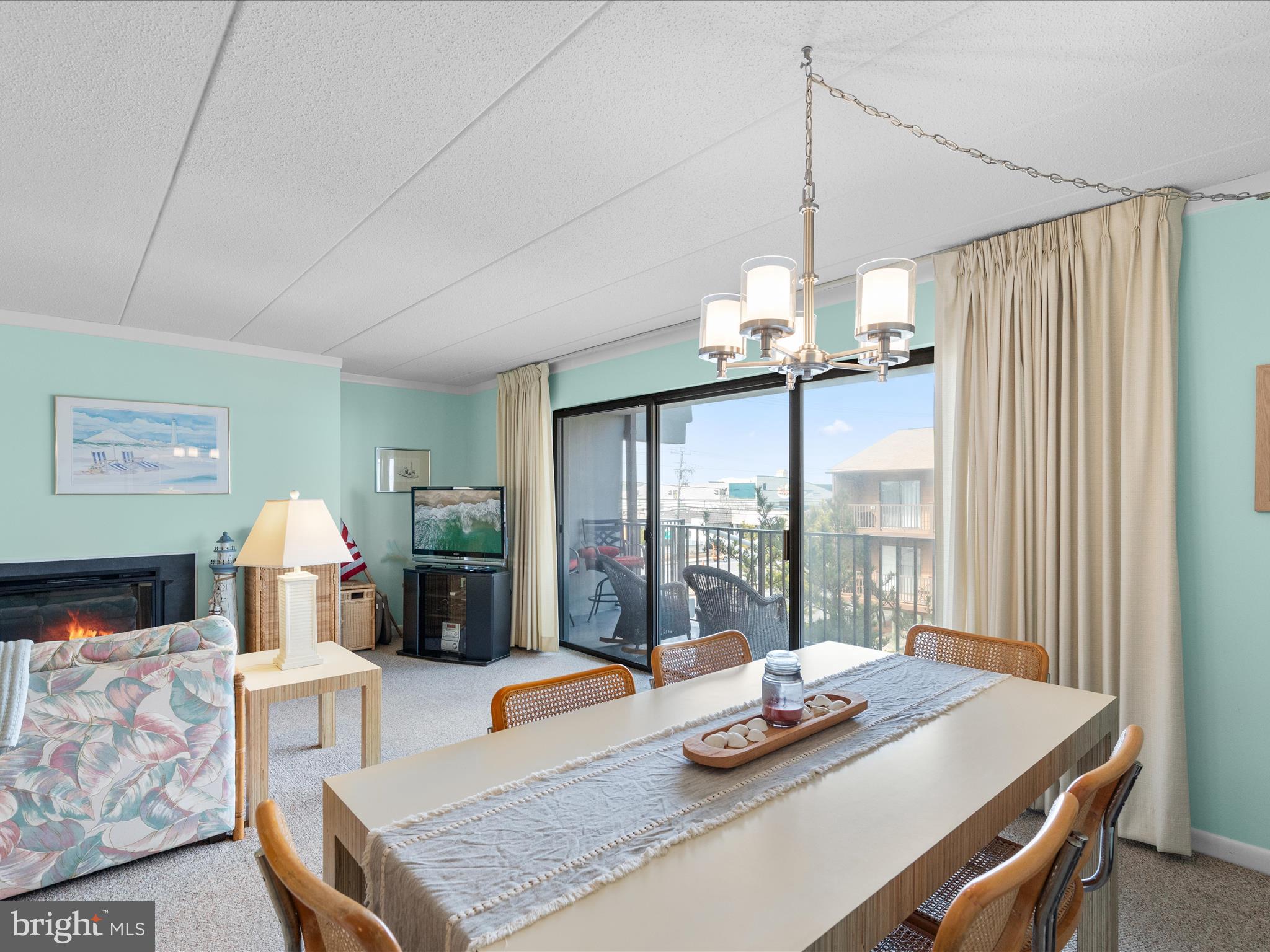 17 70th Street, Unit 25 Ocean City, MD 21842 - Photo 16 of 37 a dining room with furniture a chandelier and window
