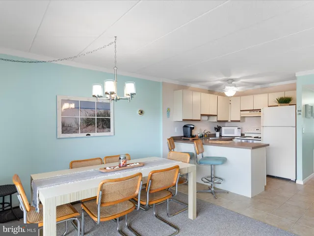 a living room with furniture and a dining table
