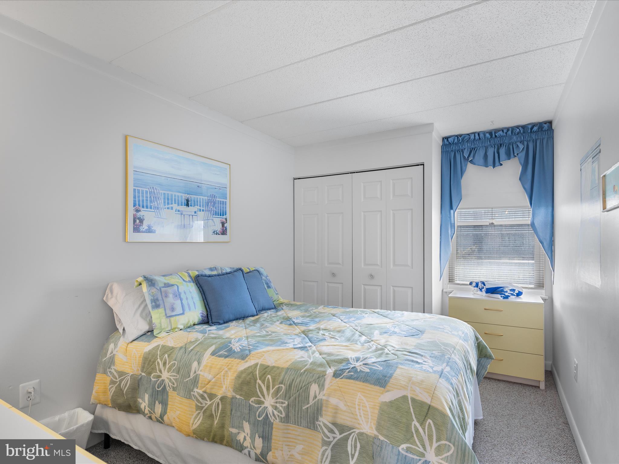 17 70th Street, Unit 25 Ocean City, MD 21842 - Photo 20 of 37 a bedroom with a bed and a painting on the wall