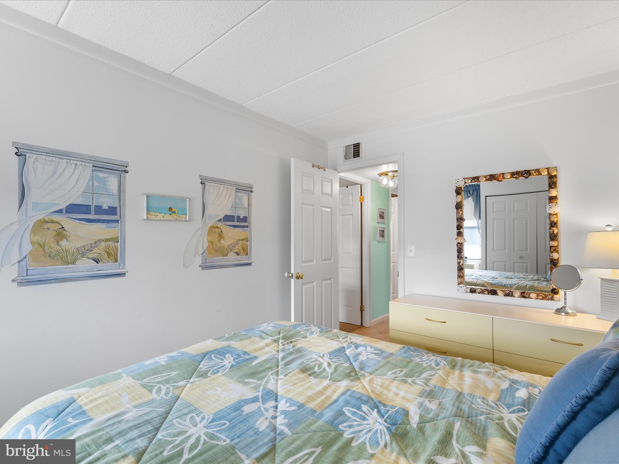 17 70th Street, Unit 25 Ocean City, MD 21842 - Photo 22 of 37 a bedroom with a bed and painting on the wall