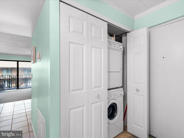 an aerial view of a balcony with chairs and a table