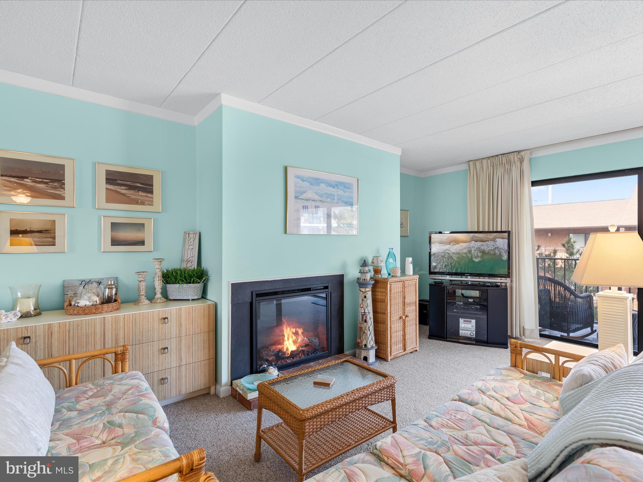 17 70th Street, Unit 25 Ocean City, MD 21842 - Photo 6 of 37 a living room with furniture a flat screen tv and a fireplace