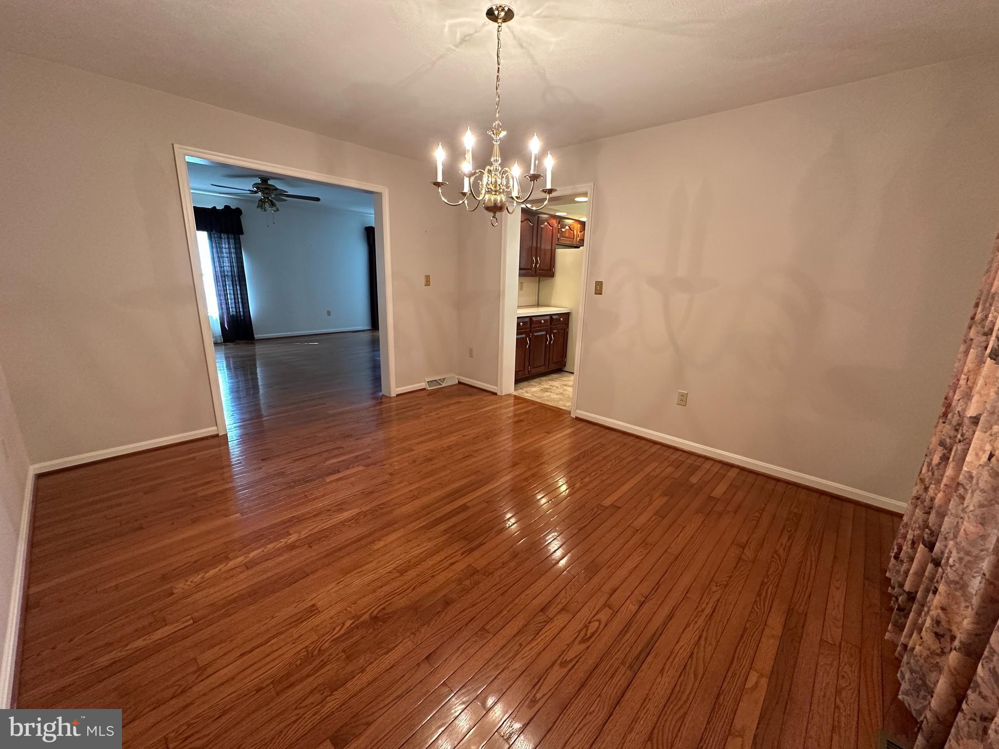 10744 Apple Tree Lane Williamsport, MD 21795 - Photo 51 of 118 a view of a livingroom with a chandelier wooden floor and a chandelier