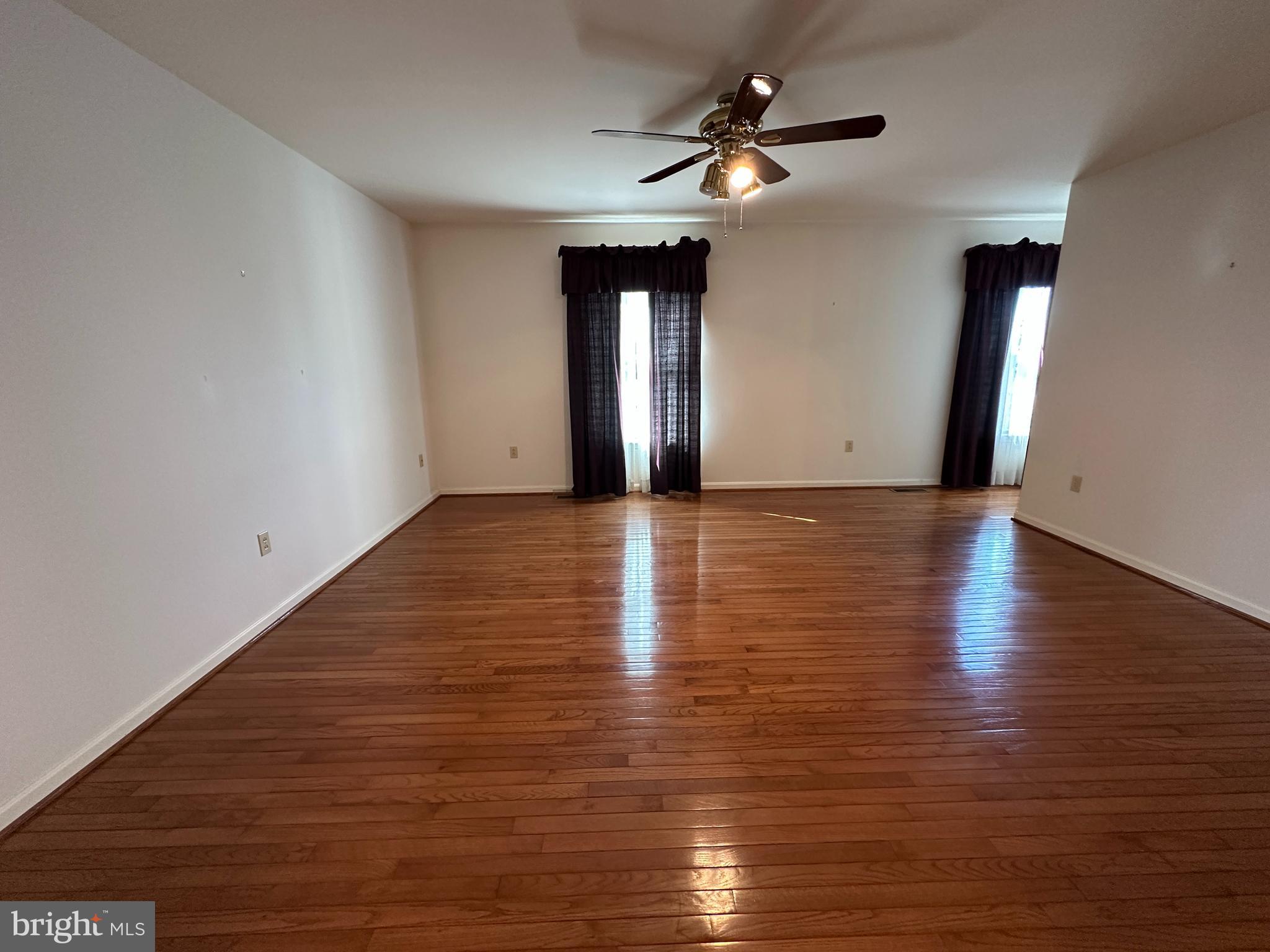 10744 Apple Tree Lane Williamsport, MD 21795 - Photo 52 of 118 a view of an empty room with window and wooden floor