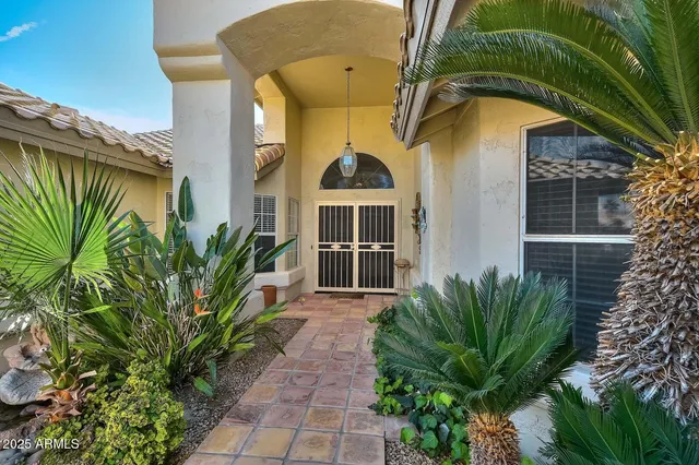a front view of a house with a garden
