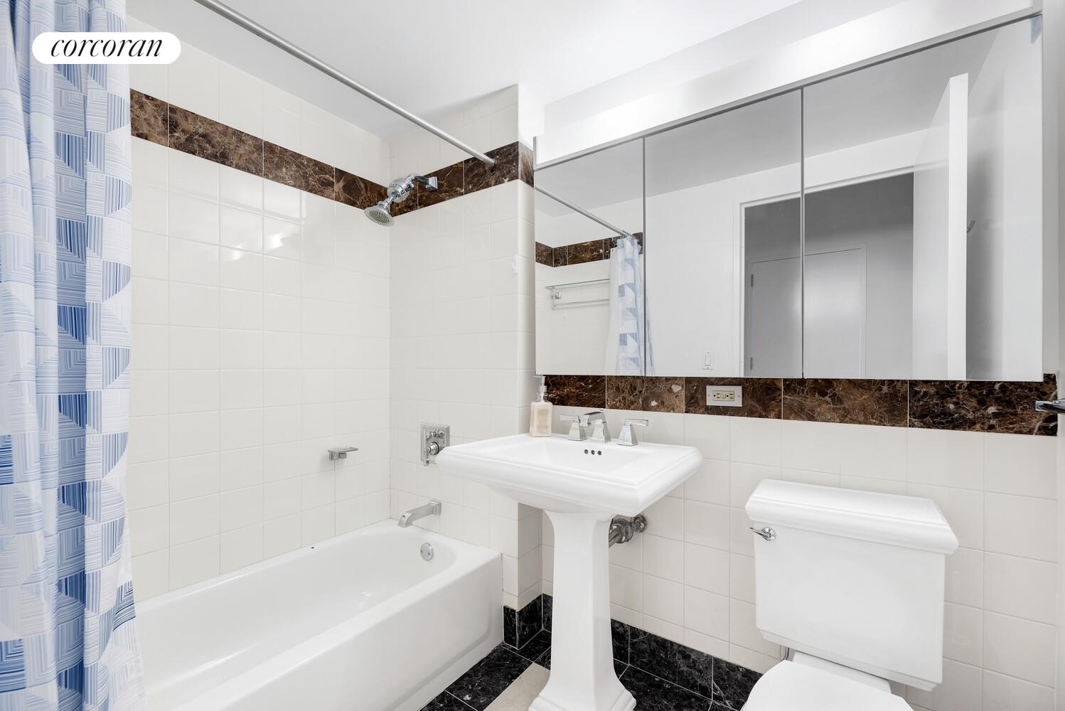 455 Main Street, Unit 16A Manhattan, NY 10044 - Photo 4 of 18 a bathroom with a sink a toilet and shower