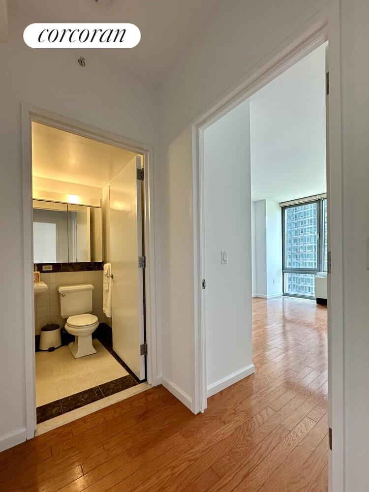 455 Main Street, Unit 16A Manhattan, NY 10044 - Photo 7 of 18 a view of a bathroom with a tub and toilet