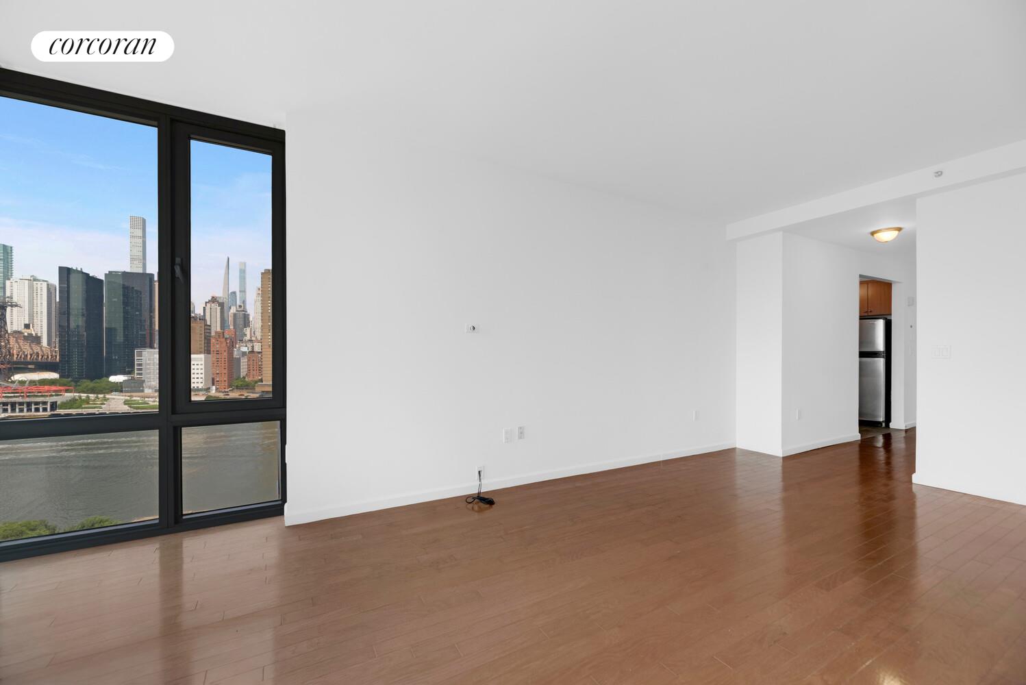 455 Main Street, Unit 16A Manhattan, NY 10044 - Photo 8 of 18 a view of a room with a floor to ceiling window and a room