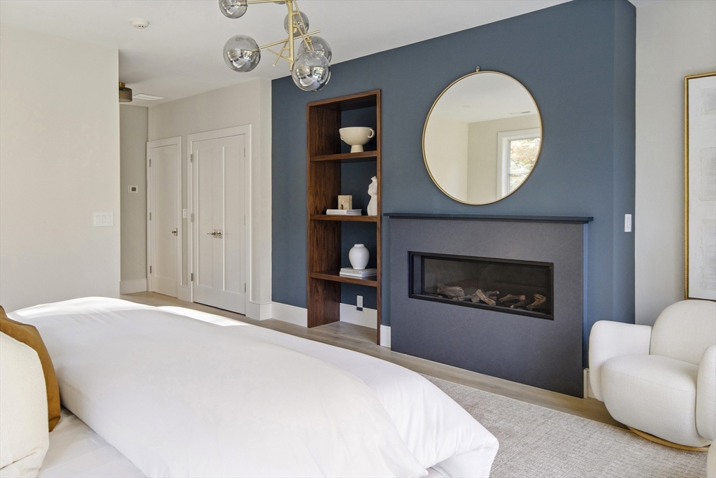 56 Bigelow Road Newton, MA 02465 - Photo 20 of 32 a bedroom with a bed and a fireplace