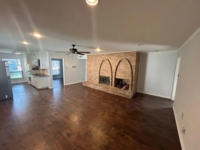 a view of living room and kitchen with furniture wooden floor and window