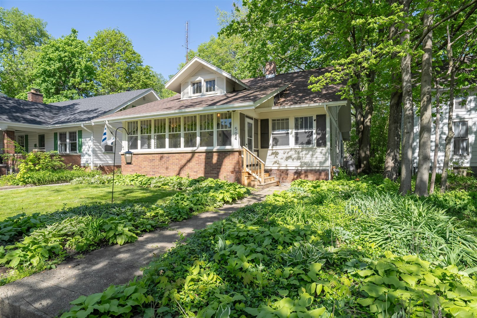 504 Normal Avenue Normal, IL 61761 - Photo 1 of 24 a front view of a house with a yard table and chairs