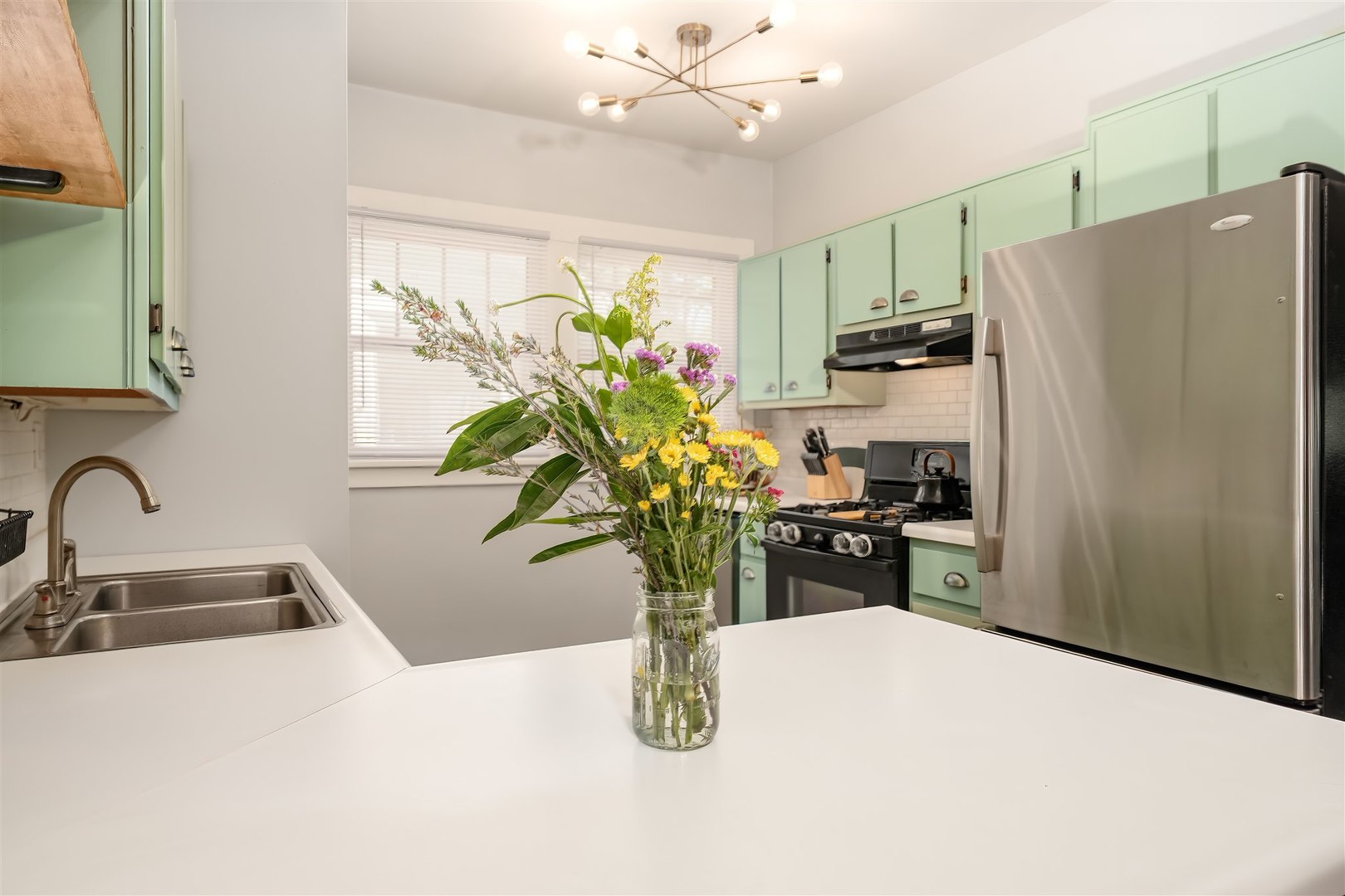 504 Normal Avenue Normal, IL 61761 - Photo 7 of 24 a kitchen with a refrigerator a sink a counter space and stainless steel appliances